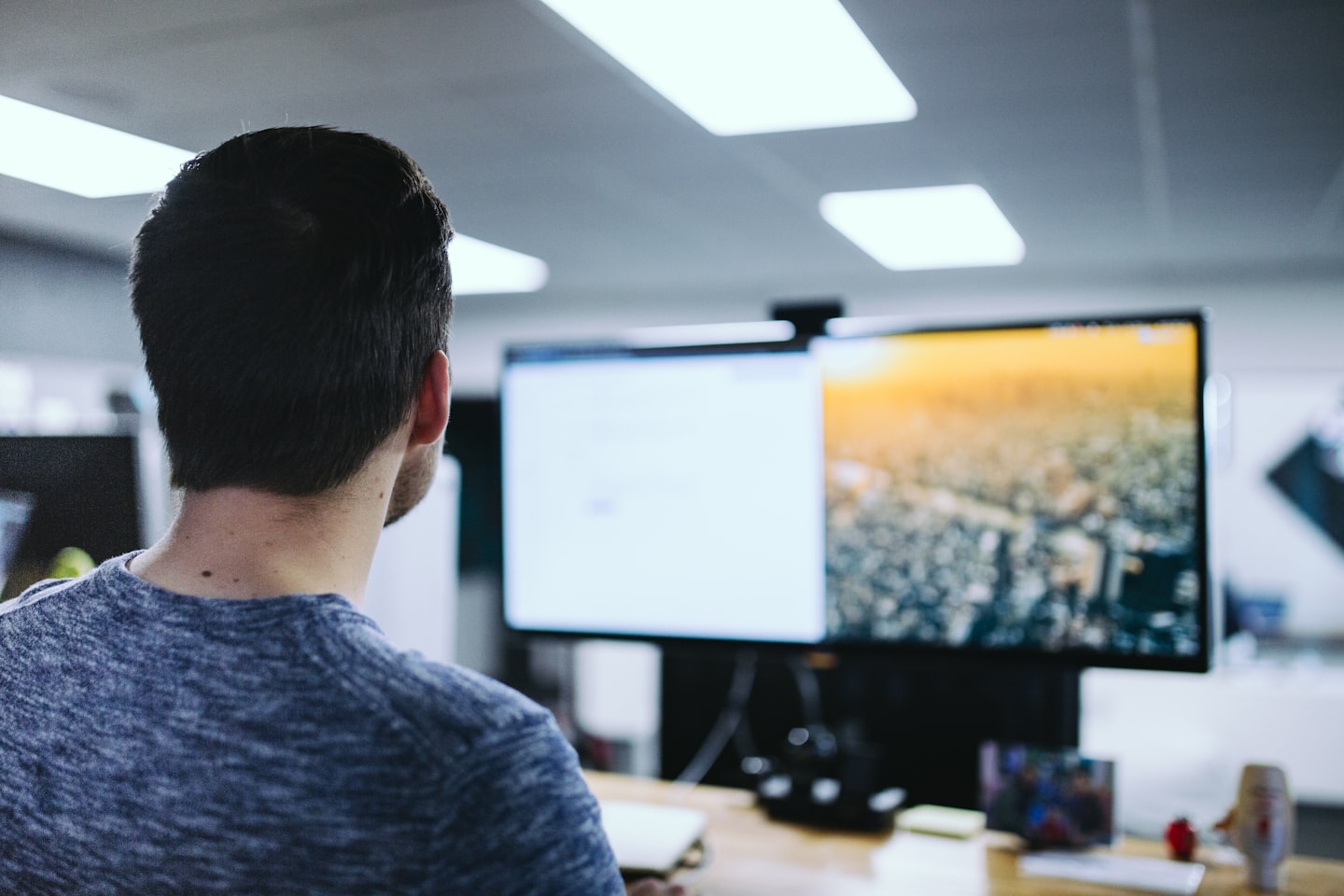 Computer monitor showing a live video stream interface in a modern workspace