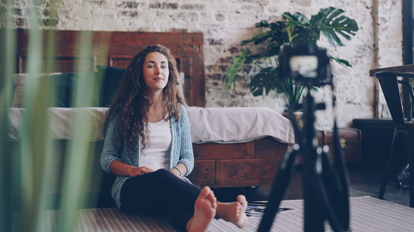 A home webcam studio with a camera, monitor, and ring light for a male webcam model starting out.