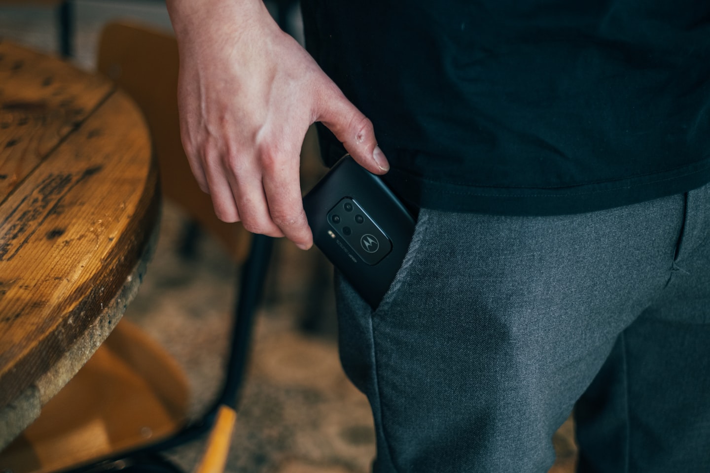 Cam model reviewing a live streaming setup on a smartphone in a private studio environment