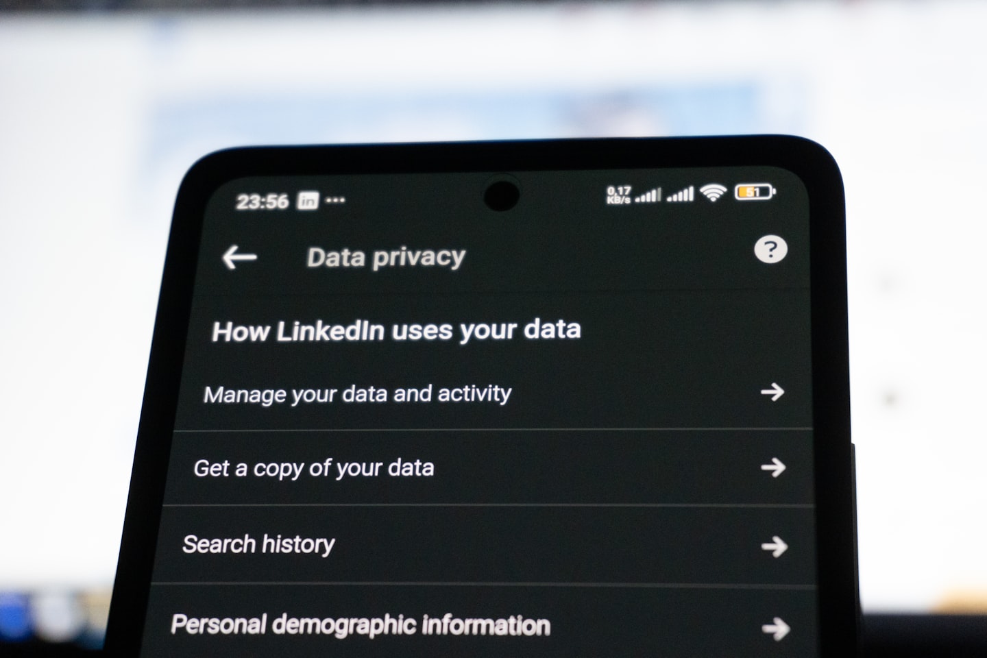 Person checking a phone screen during a live streaming privacy issue, representing immediate response and documentation
