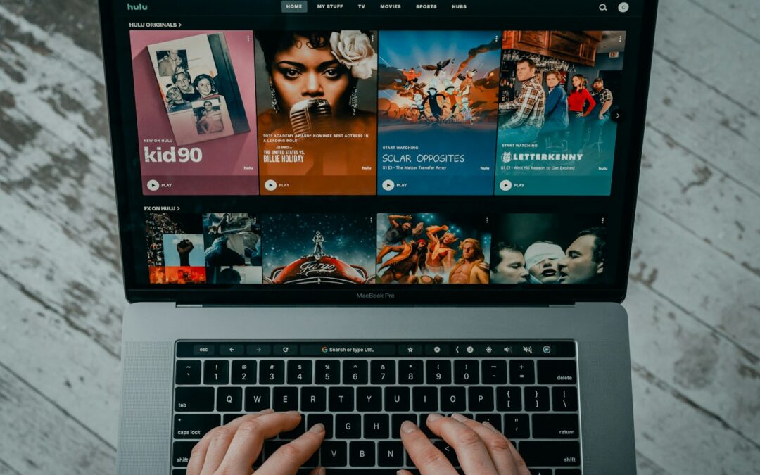 Founder reviewing an OTT streaming dashboard with content tiles, pricing options, and analytics on screen