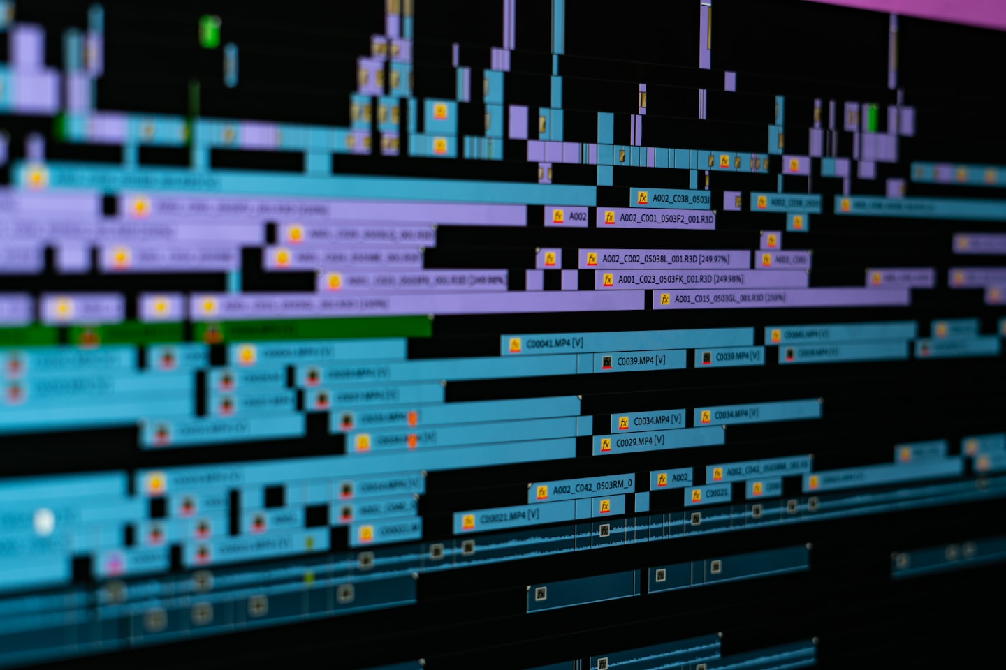 Editing software interface on a monitor showing bitrate and export settings for video
