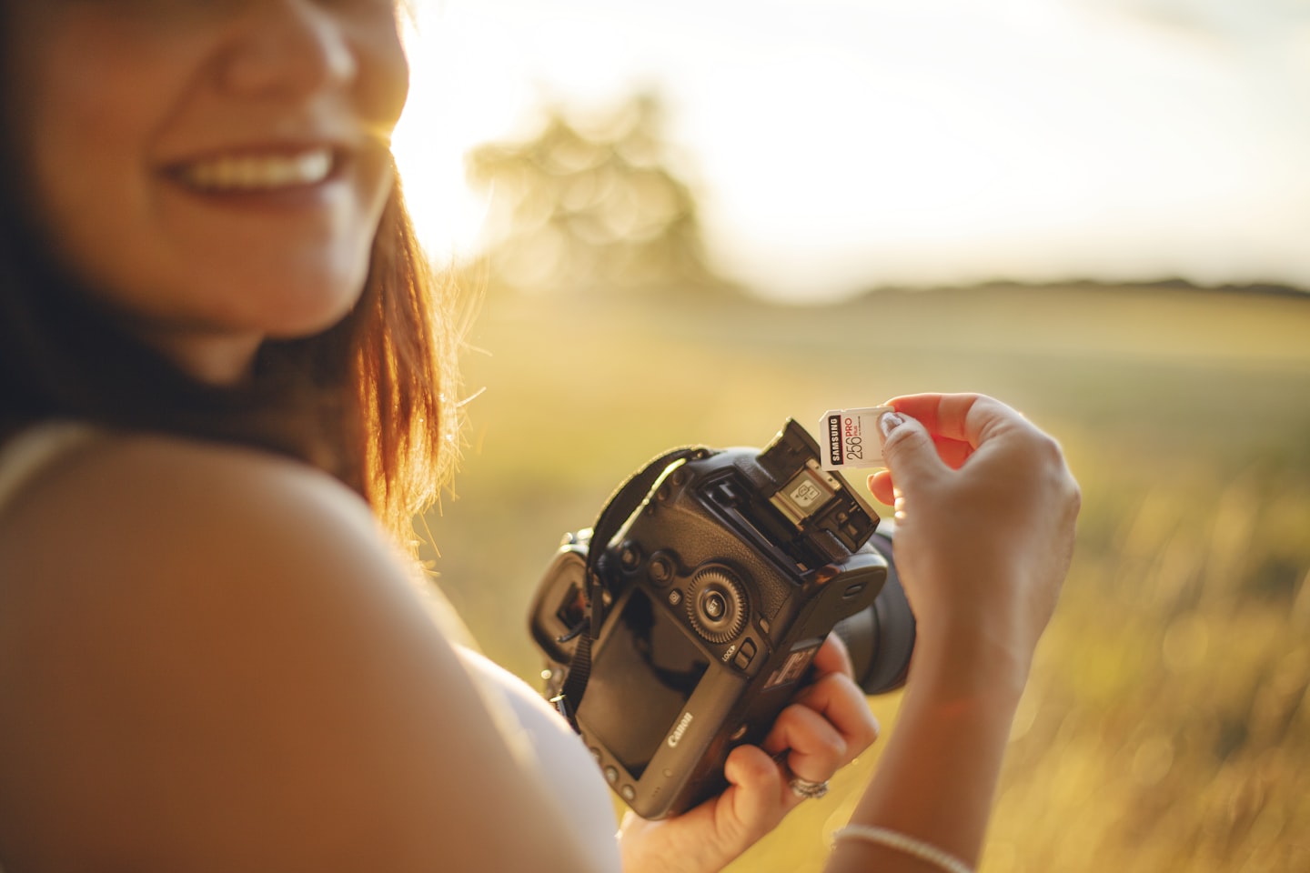 woman holding black dslr camera during daytime