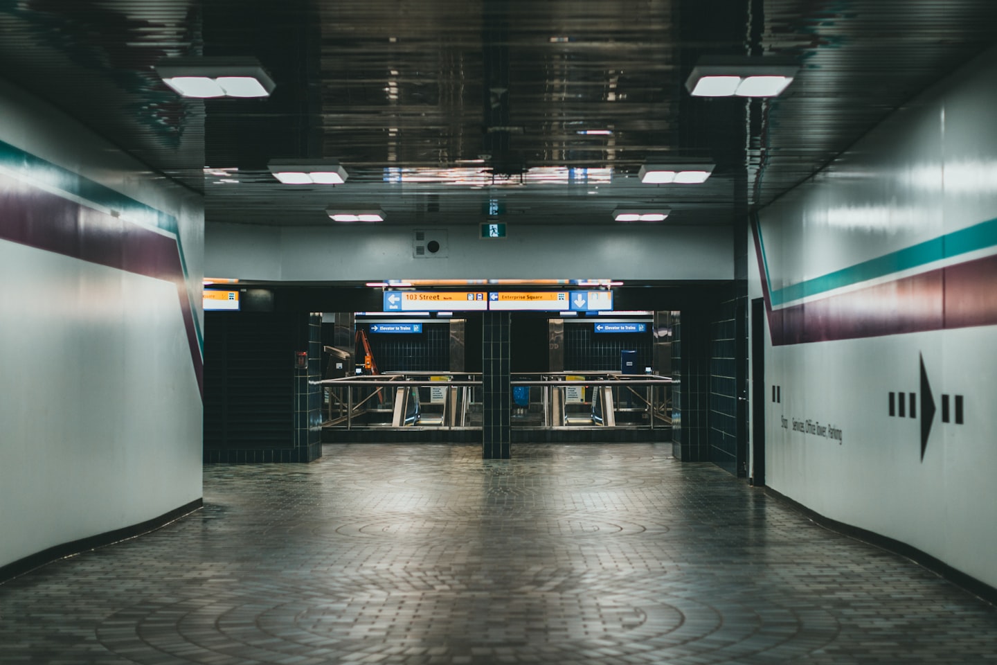 a long hallway with two doors leading to another room