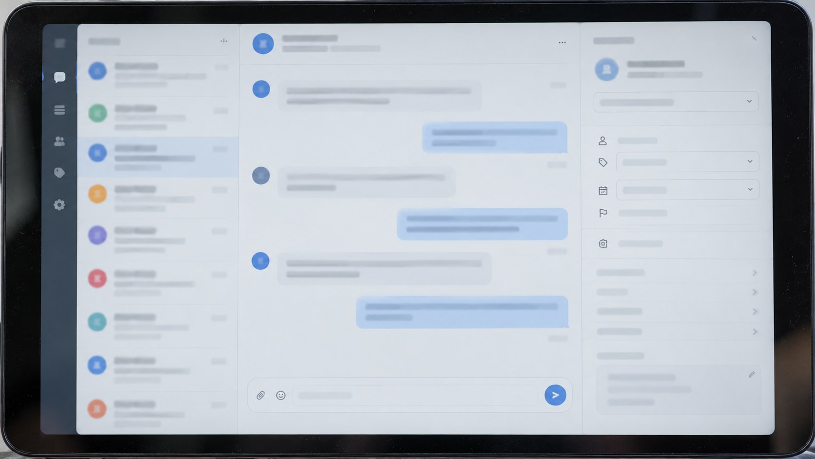 Close frontal photograph of a tablet displaying an indistinct support conversation beside a compact case-assignment panel.